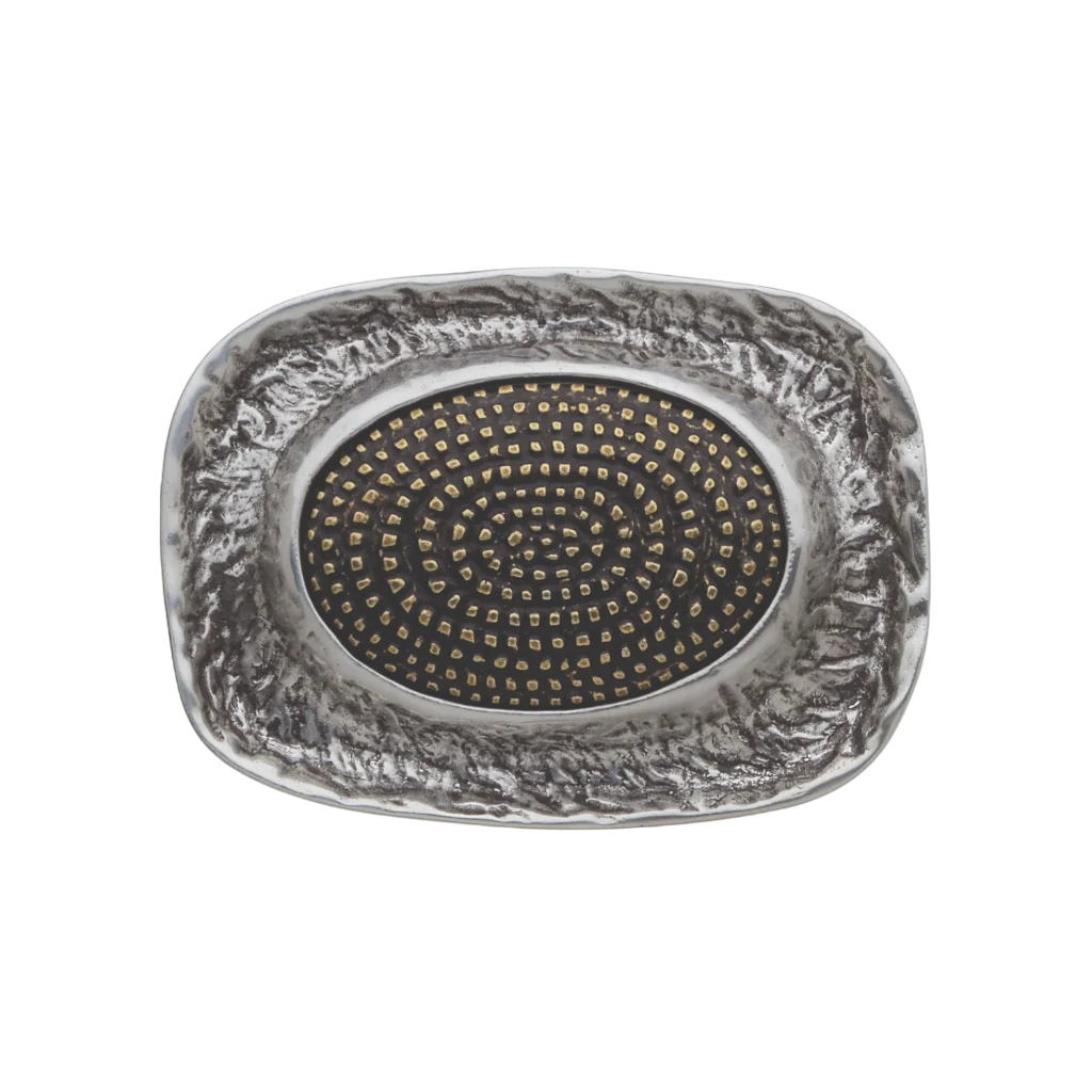 Unique rectangular silver belt buckle with a textured stone-like border and a central oval black inlay with a spiral dot design, a modern and elegant fashion accessory with an Italian design.