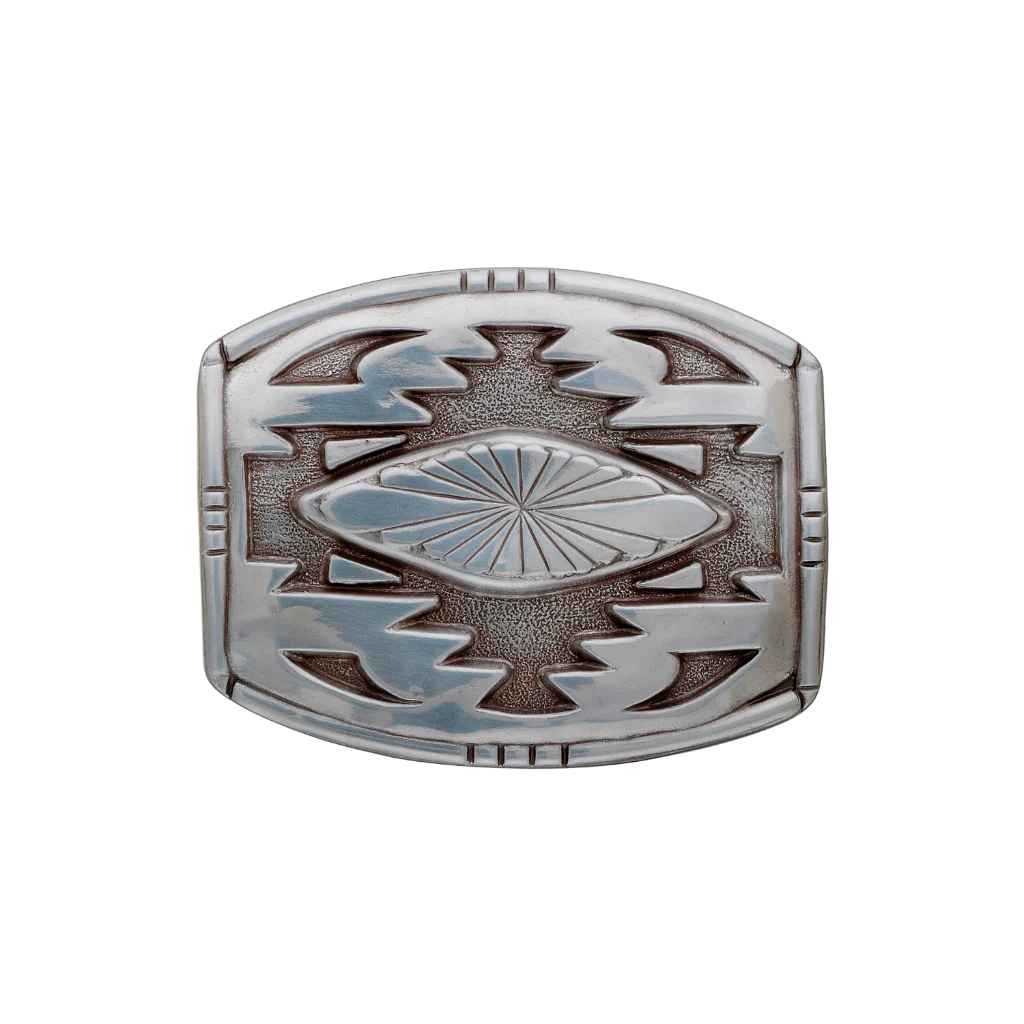 A detailed silver belt buckle with a Southwestern-style design. This fashion accessory features a central fluted pattern surrounded by bold geometric motifs and a textured background.