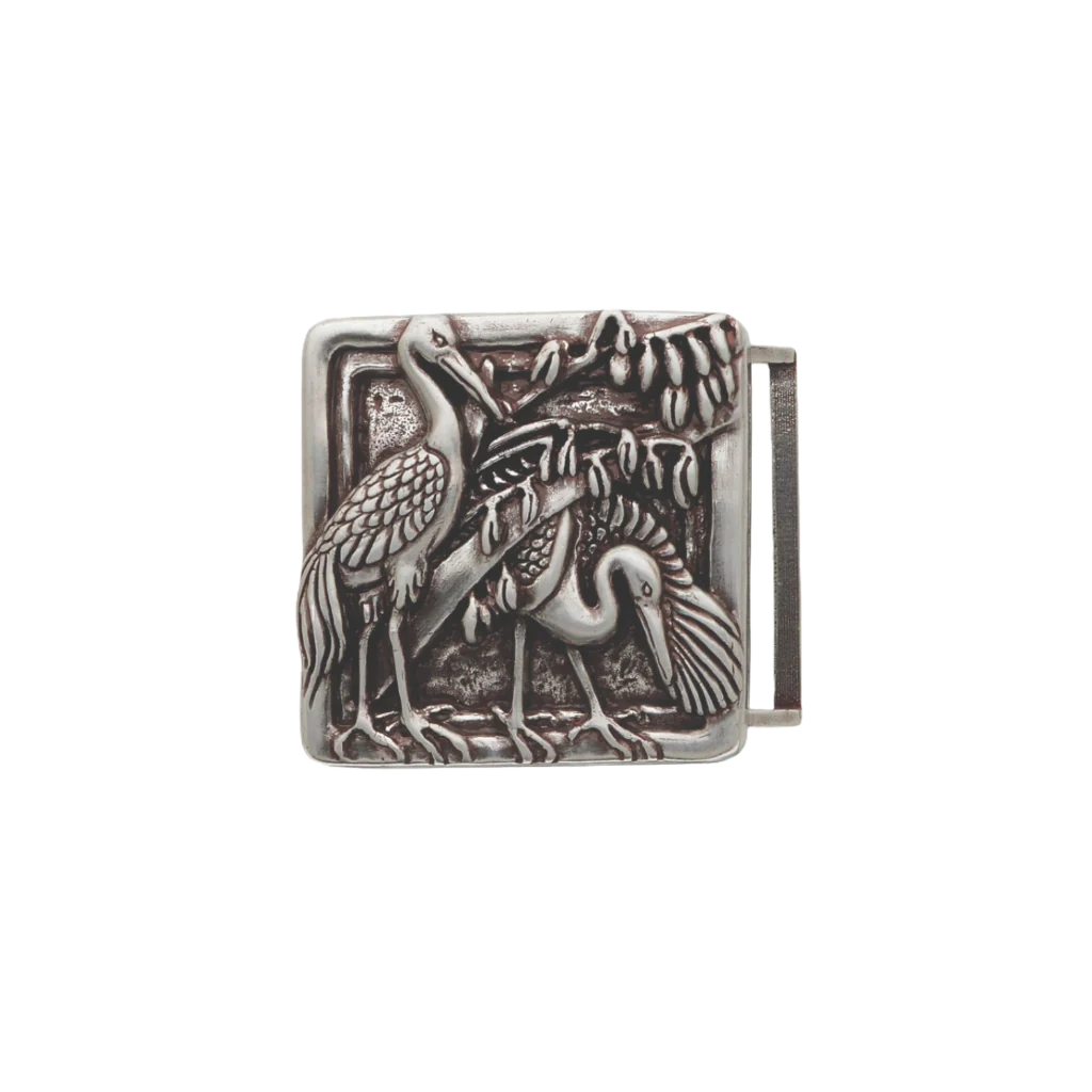 Detailed square silver belt buckle with a raised textured design of two herons or cranes and foliage, a unique fashion accessory with a beautiful Italian design.


