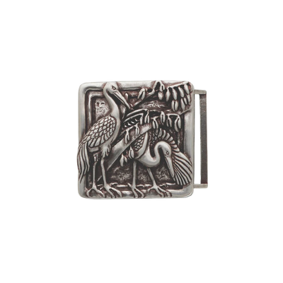 Detailed square silver belt buckle with a raised textured design of two herons or cranes and foliage, a unique fashion accessory with a beautiful Italian design.

